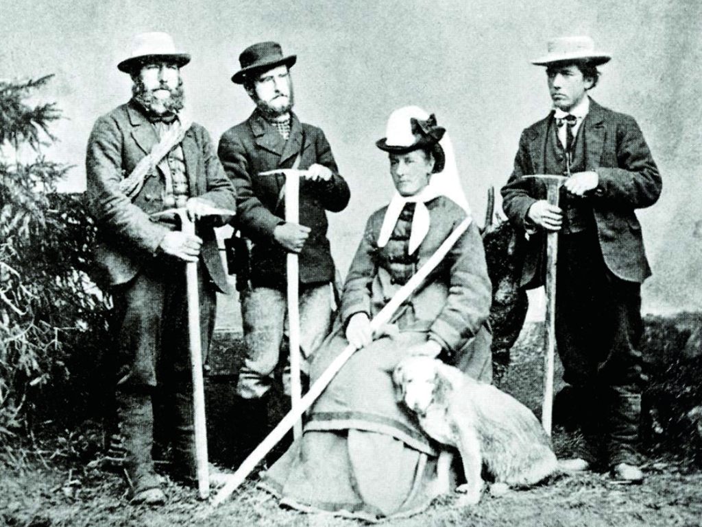 Studio image of four Victorian mountaineers, one a seated woman holding a dog